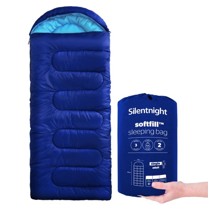 Image of a blue Silentnight Adult Sleeping Bag with a hand holding the bag it goes in