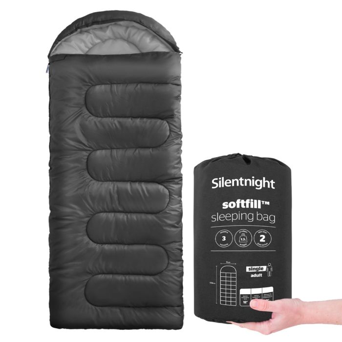Image of a black Silentnight Adult Sleeping Bag with a hand holding the bag it goes in