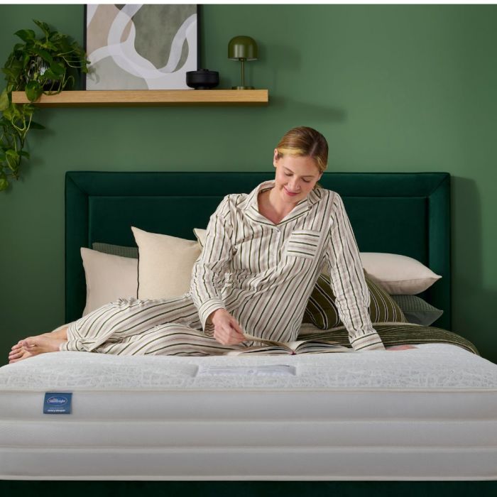 Comfort Breathe™ 2000 Pocket Mattress person sitting on the mattress