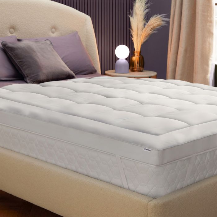 The Silentnight Deep Sleep Ultimate 1000 Mattress Topper on top of a bed in a purple room