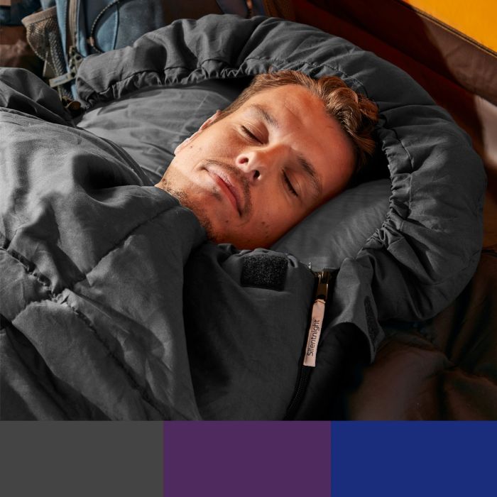 A man sleeping in a black Silentnight Adults Sleeping Bag whilst showcasing 3 different colour options