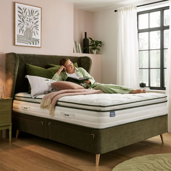 model reading on a green bed with a Silentnight Comfort Breathe™ Plus 2100 Pocket Pillowtop Mattress