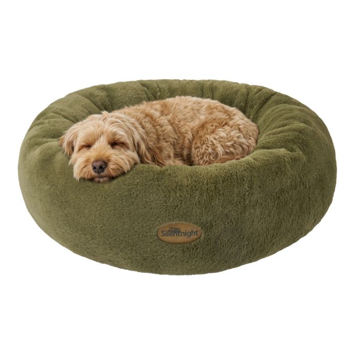A dog sleeping on a Green Silentnight Calming Donut Pet Bed 