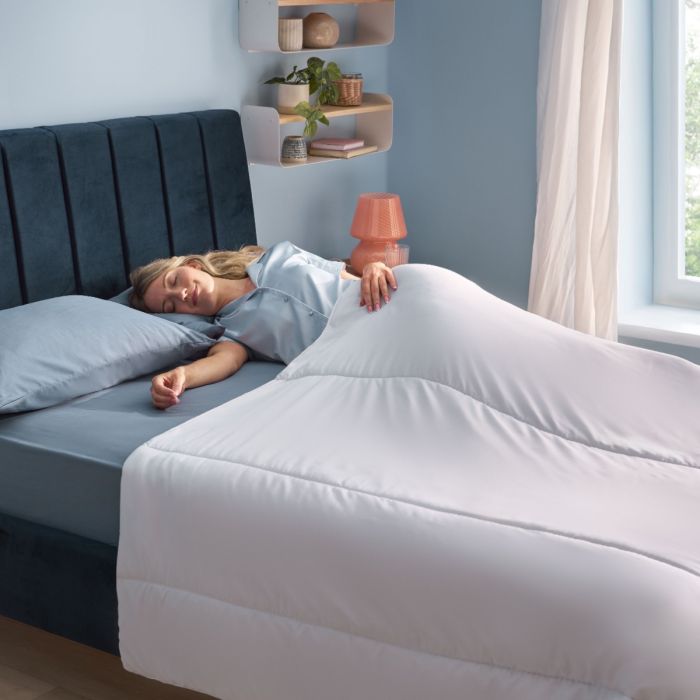 A person sleeping in the Silentnight Summer Breeze Duvet.