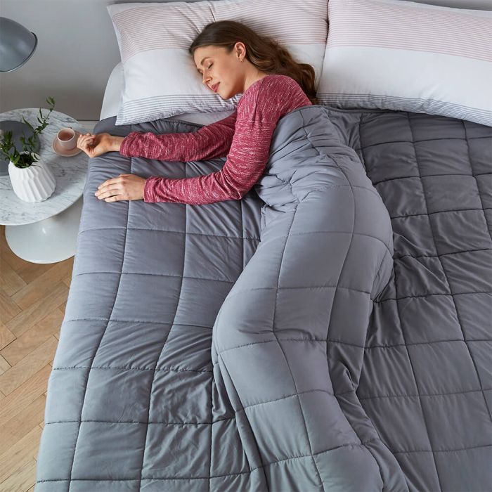 Woman asleep with Silentnight weighted blanket
