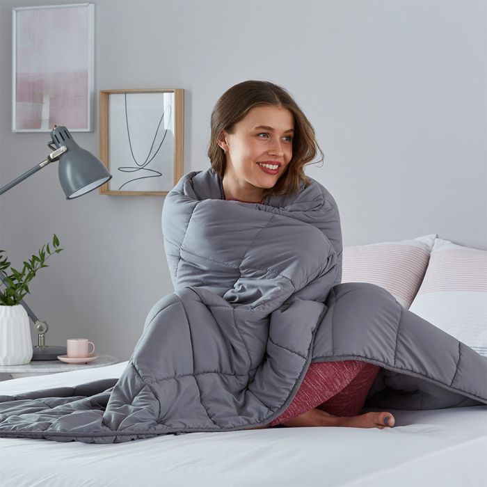 woman wrapped up in weighted blanket